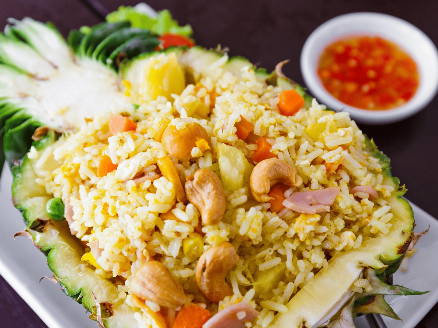 Thai pineapple fried rice with cashews, egg, vegetables, and sweet chili sauce